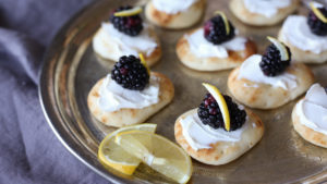 Juicy blackberries and zesty lemon atop creamy mascarpone on Stonefire® Naan Dippers® for a refreshing appetizer idea.