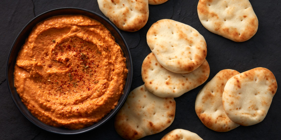 Stonefire® Naan Dippers® paired with creamy hummus in a rustic serving bowl, ready to enjoy.