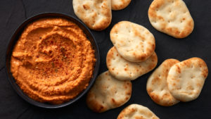 Stonefire® Naan Dippers® paired with creamy hummus in a rustic serving bowl, ready to enjoy.