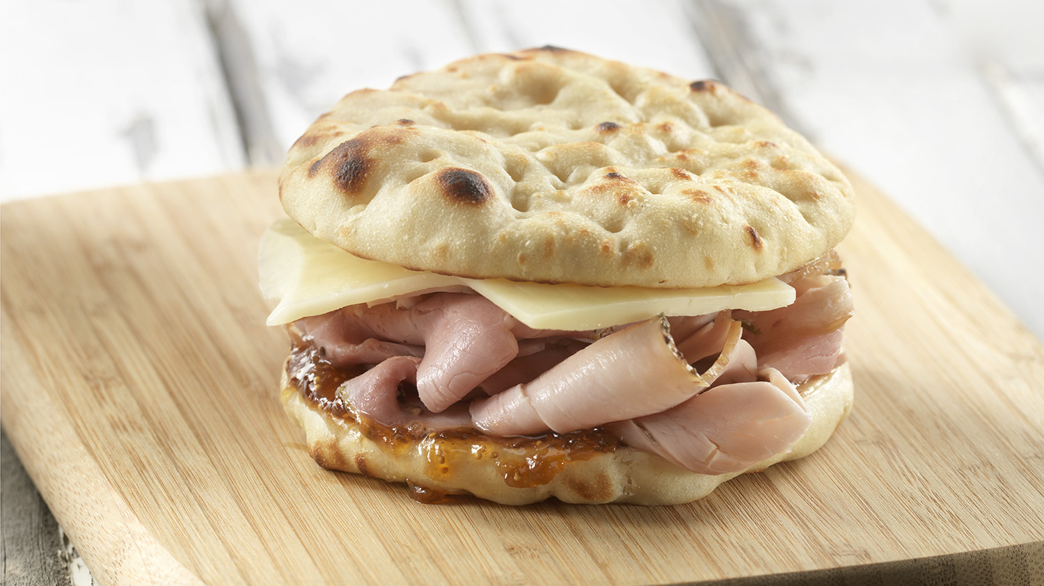 An easy and quick ham and cheese sandwich with Stonefire Original Naan Rounds