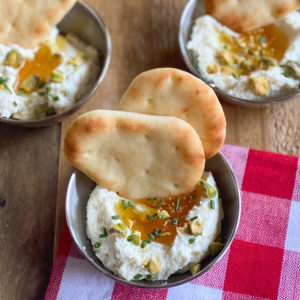 Whipped feta dip paired with golden, buttery Stonefire® Naan Dippers® presented as a creamy and inviting appetizer.