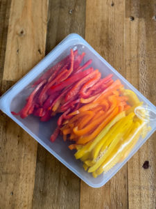 red oranger and yellow peppers sliced in reusable bag