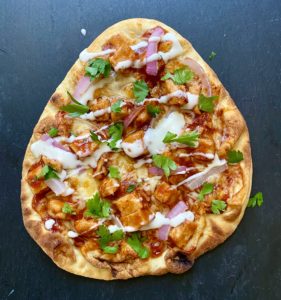Crispy naan pizza nestled in an air fryer, ready to be devoured.